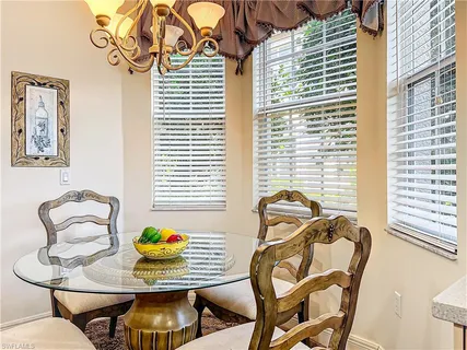 a view of a dining room with furniture and windows