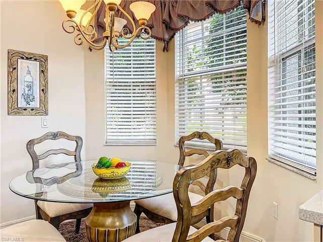 a view of a dining room with furniture and windows