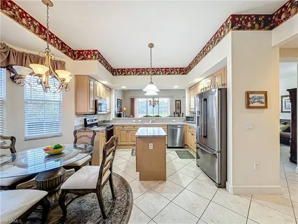 a large kitchen with a table and chairs