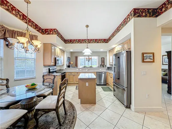 a large kitchen with a table and chairs