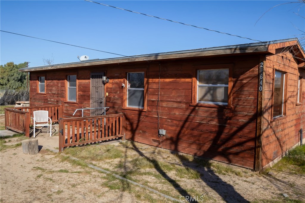 25640 Jasper Road Barstow, CA 92311 - Photo 3 of 48 a front view of a house with wooden fence