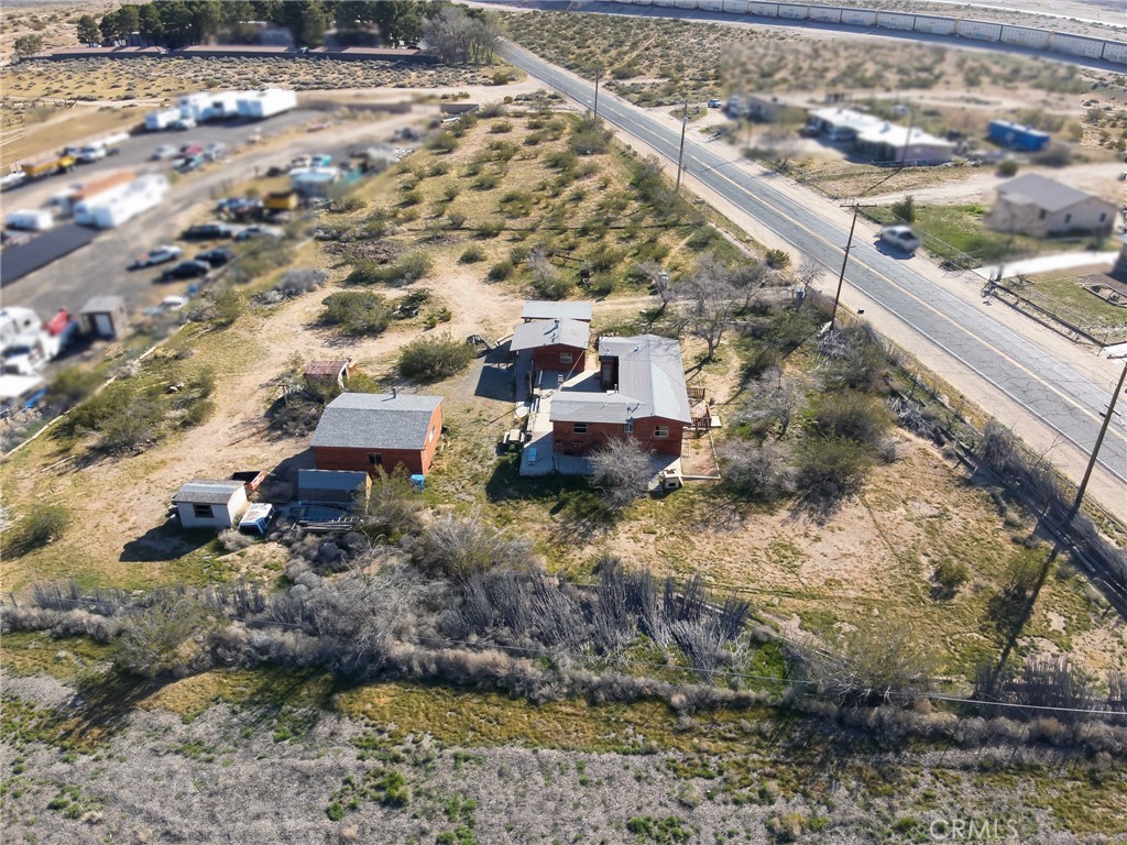 25640 Jasper Road Barstow, CA 92311 - Photo 43 of 48 a aerial view of a house with a yard and large trees