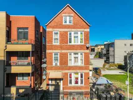 a front view of a residential apartment building with a yard