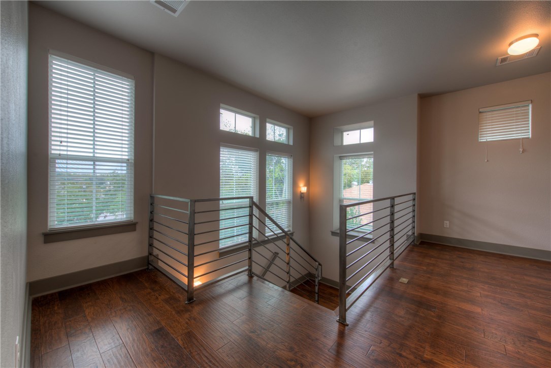 3110 Grandview Street Austin, TX 78705 - Photo 13 of 30 a view of an empty room with wooden floor and a window