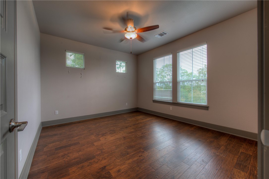 3110 Grandview Street Austin, TX 78705 - Photo 15 of 30 an empty room with wooden floor chandelier fan and windows