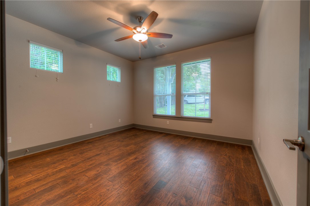 3110 Grandview Street Austin, TX 78705 - Photo 22 of 30 a view of an empty room with wooden floor and a window