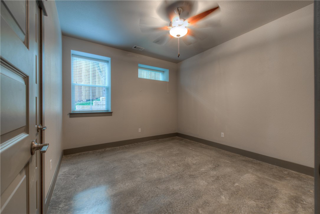 3110 Grandview Street Austin, TX 78705 - Photo 25 of 30 an empty room with a chandelier fan and windows