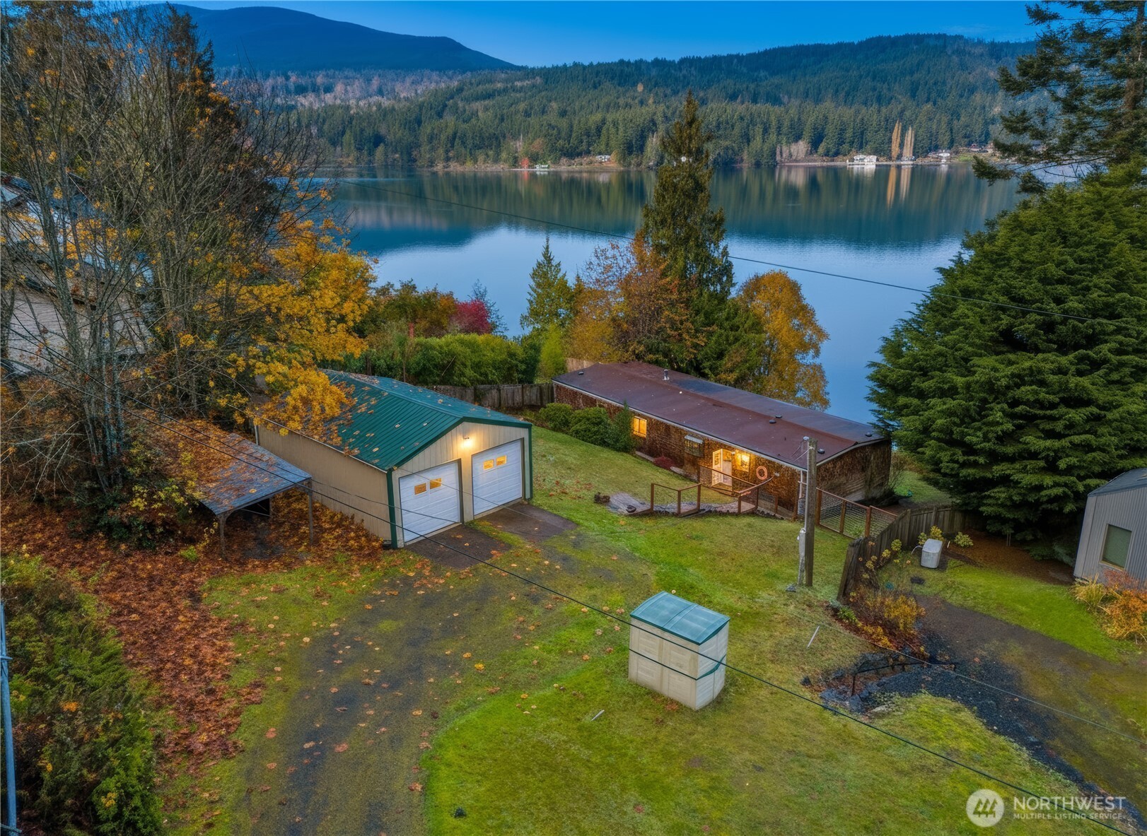 813 Fairmount Road Port Townsend, WA 98368 - Photo 23 of 30 a view of a lake with a yard and a large tree