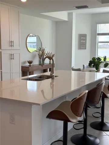 a dining room with table chairs and wooden floor
