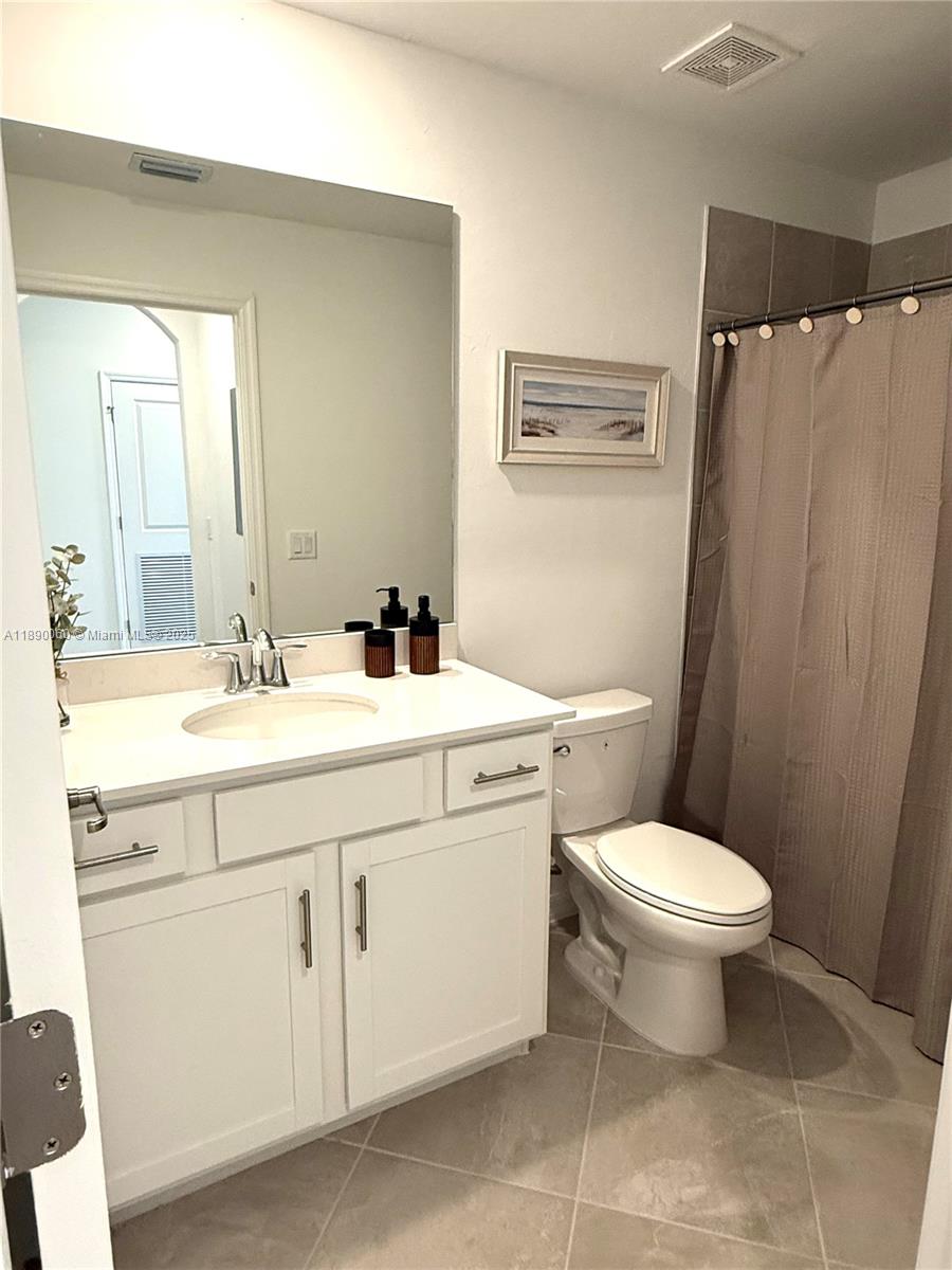 5555 Double Eager Circle, Unit 3917 Immokalee, FL 34142 - Photo 11 of 16 a bathroom with a toilet sink and a mirror