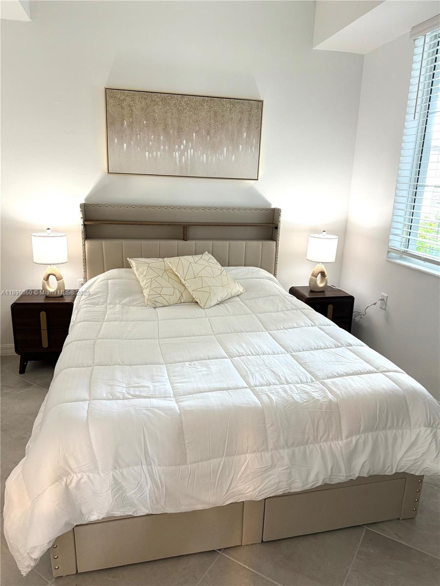 5555 Double Eager Circle, Unit 3917 Immokalee, FL 34142 - Photo 12 of 16 a large white bed in a small room