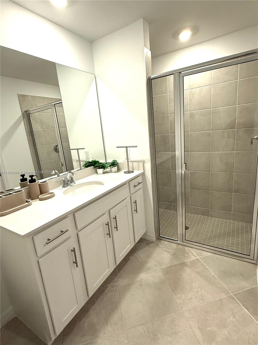 5555 Double Eager Circle, Unit 3917 Immokalee, FL 34142 - Photo 14 of 16 a spacious bathroom with a shower sink and mirror
