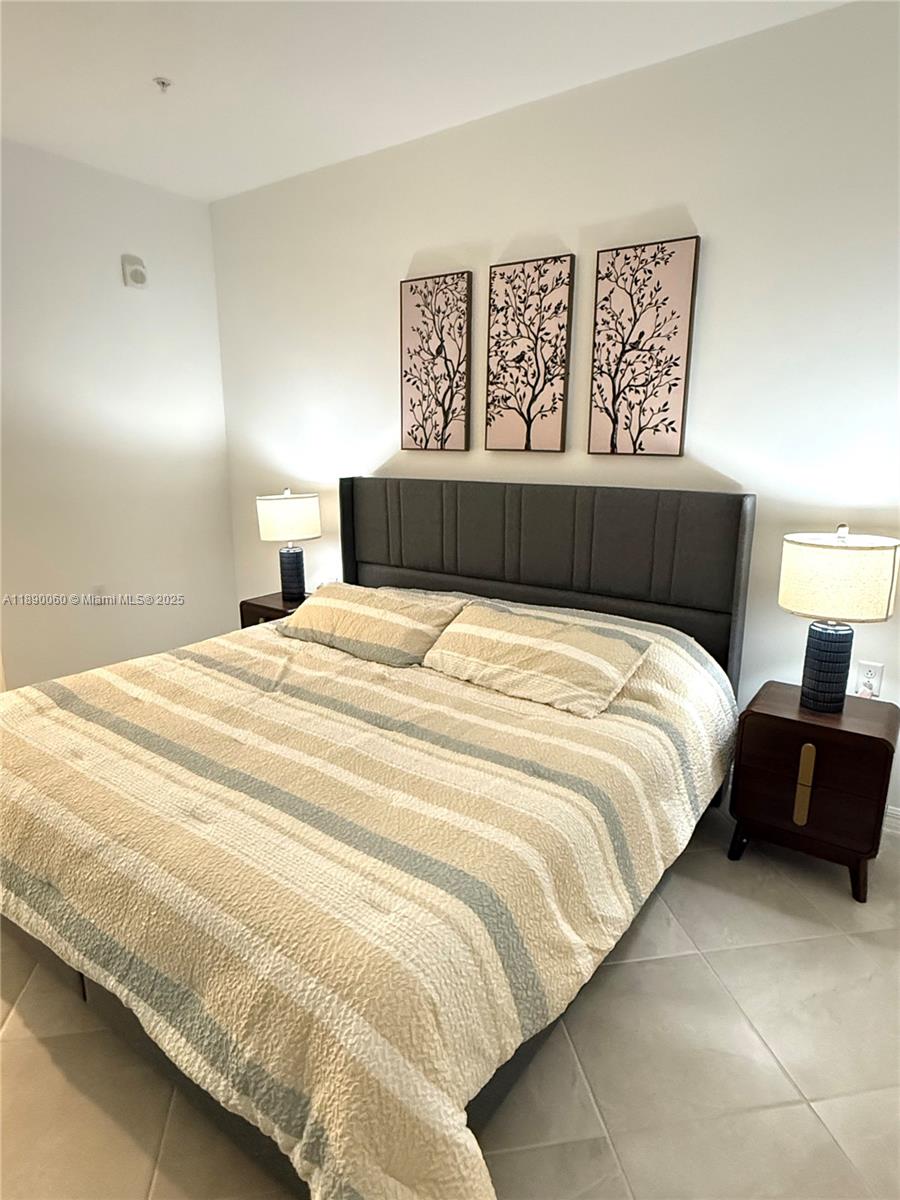 5555 Double Eager Circle, Unit 3917 Immokalee, FL 34142 - Photo 15 of 16 a bedroom with a bed and a night stand