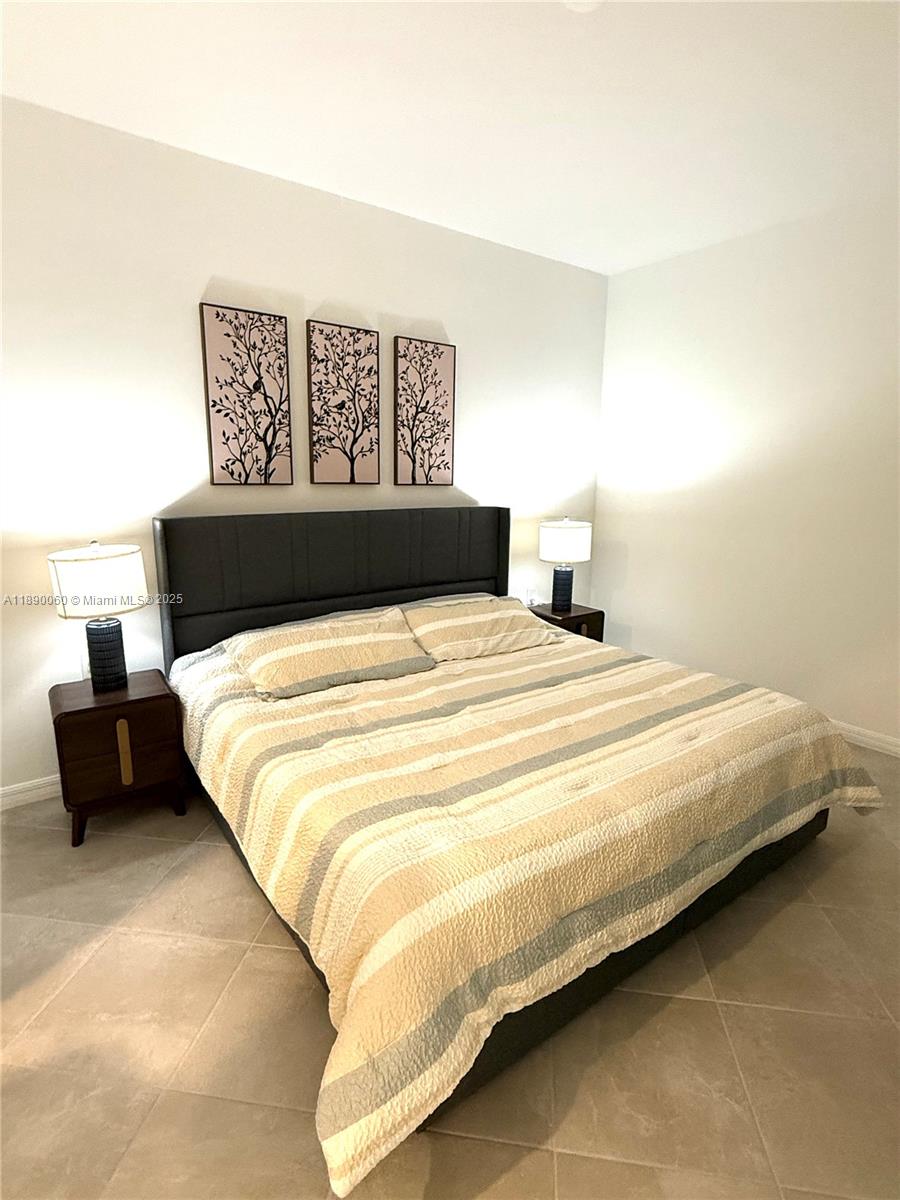 5555 Double Eager Circle, Unit 3917 Immokalee, FL 34142 - Photo 16 of 16 a large bed sitting in a bedroom and a table