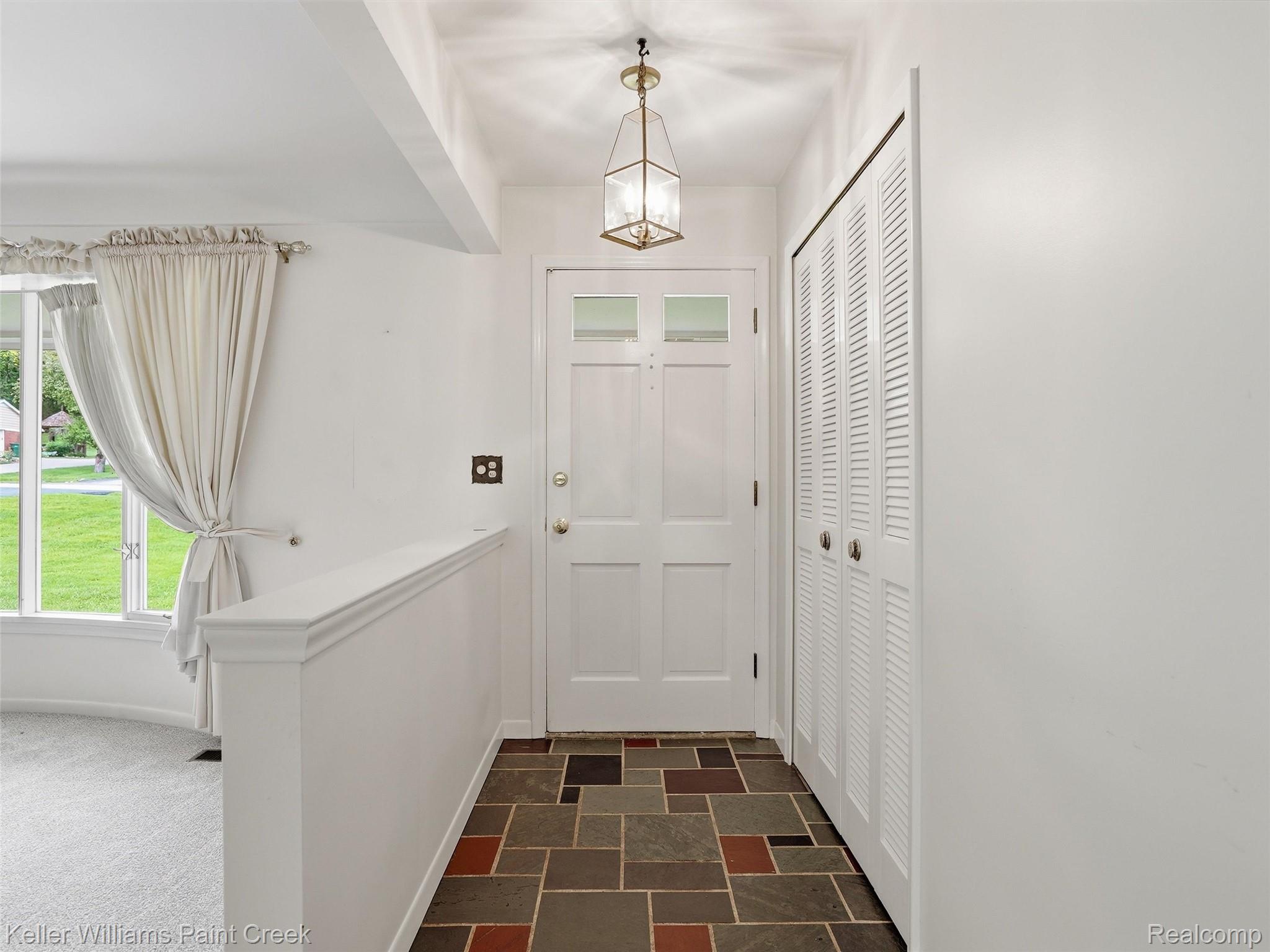 436 Broadleaf Drive Rochester, MI 48306 - Photo 9 of 41 Foyer entrance with stone finish flooring and suspended lighting
