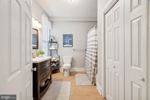 a bathroom with a sink a toilet and shower curtain