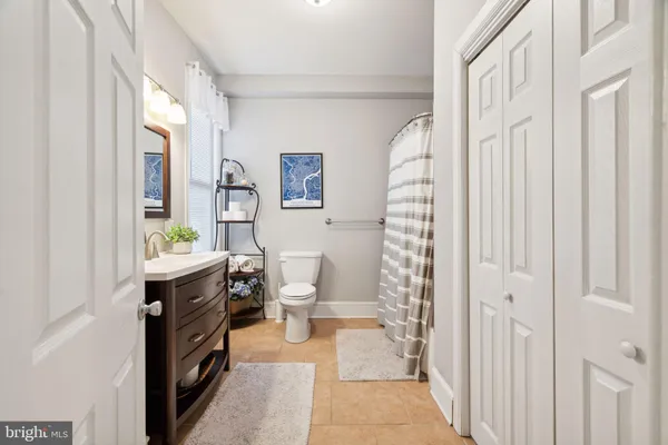 a bathroom with a sink a toilet and shower curtain
