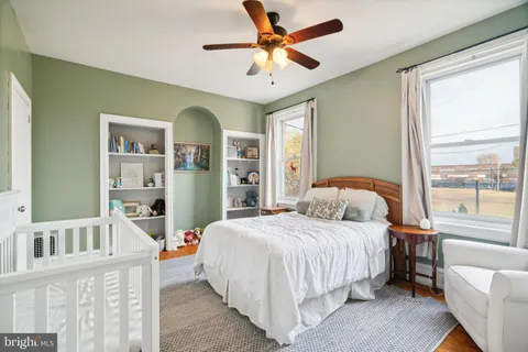 a bedroom with a bed furniture and a large window