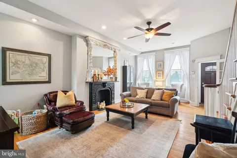 a living room with furniture and a fireplace