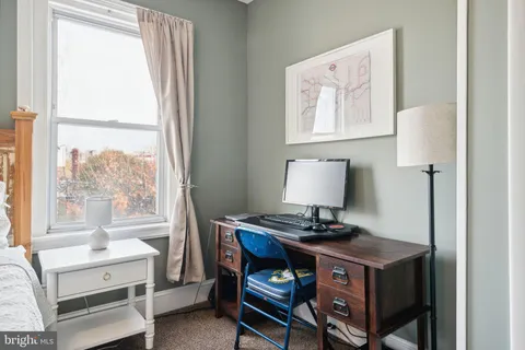 a view of workspace with a window and cabinet