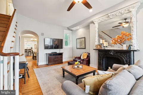 a living room with furniture a fireplace and a flat screen tv