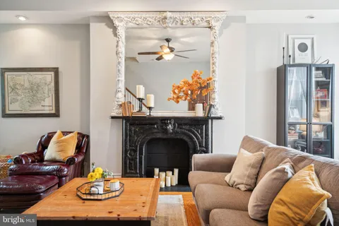a living room with furniture and a fireplace