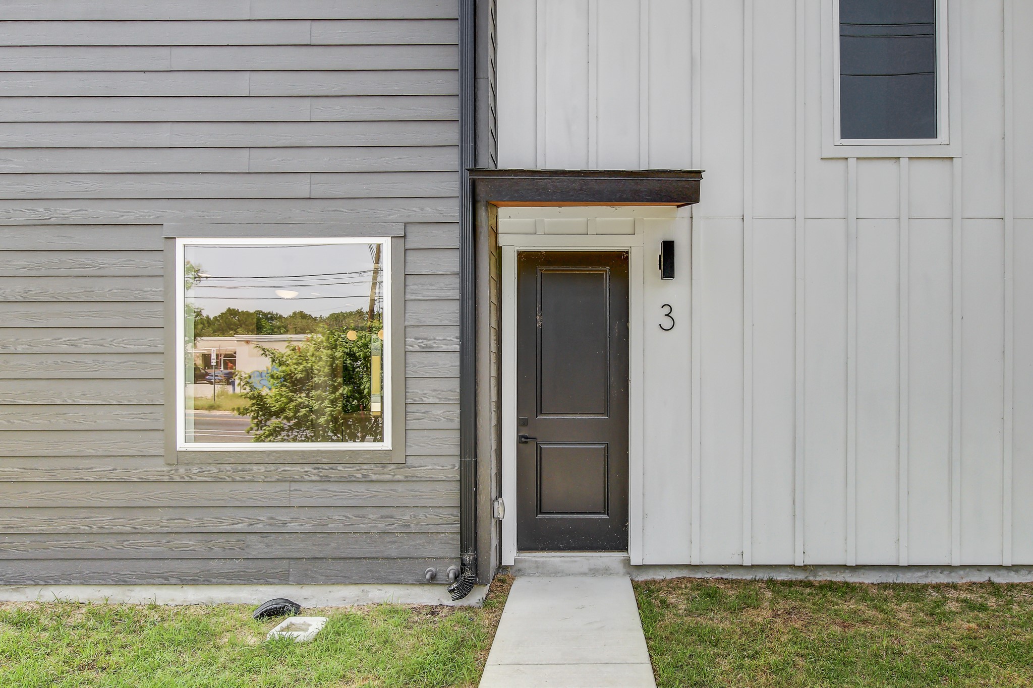 4127 East 12th Street, Unit 3 Austin, TX 78721 - Photo 29 of 29 Property entrance with board and batten siding