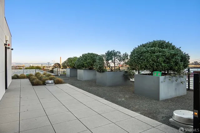 a view of a chairs and table in a balcony
