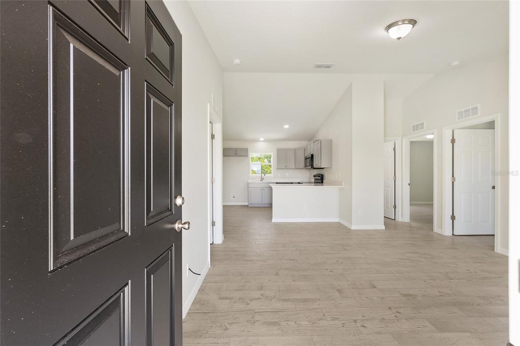 29 Olive Cir Loop Ocala, FL 34472 - Photo 12 of 49 a view of a hallway with kitchen island and stainless steel appliances
