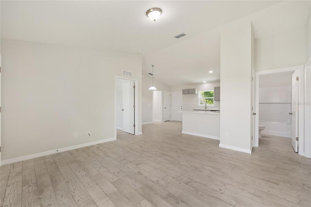 29 Olive Cir Loop Ocala, FL 34472 - Photo 14 of 49 wooden floor in an empty room with a kitchen
