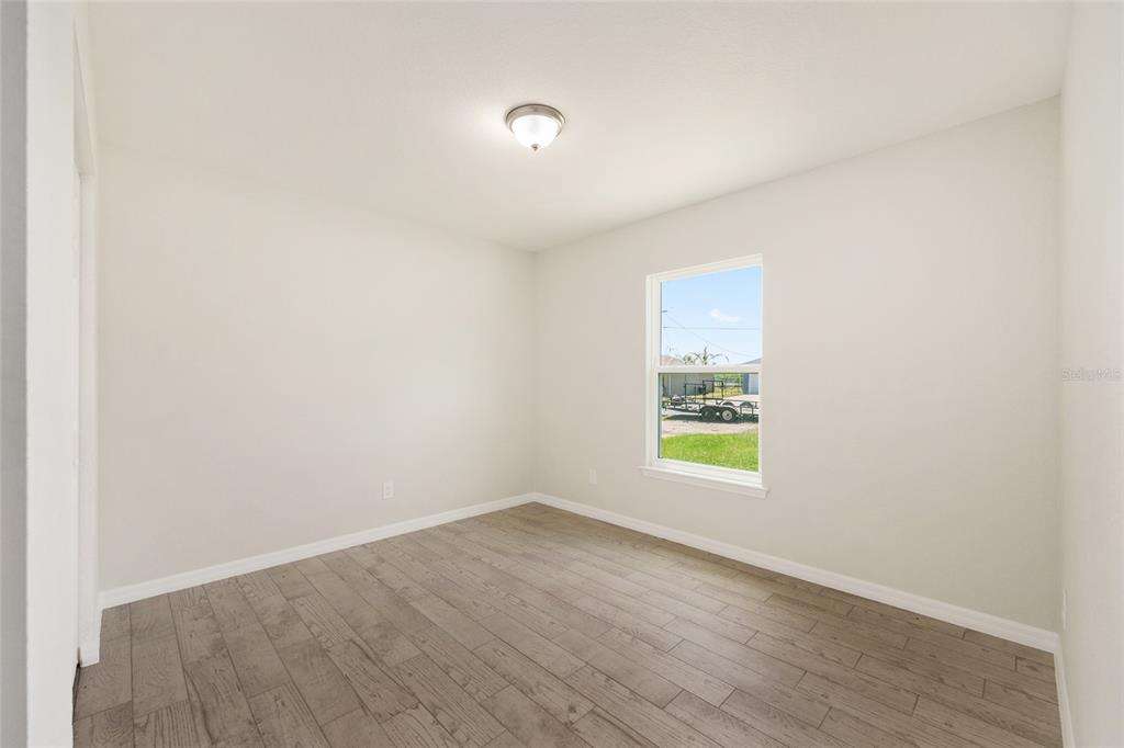 29 Olive Cir Loop Ocala, FL 34472 - Photo 26 of 49 a view of an empty room with wooden floor and a window
