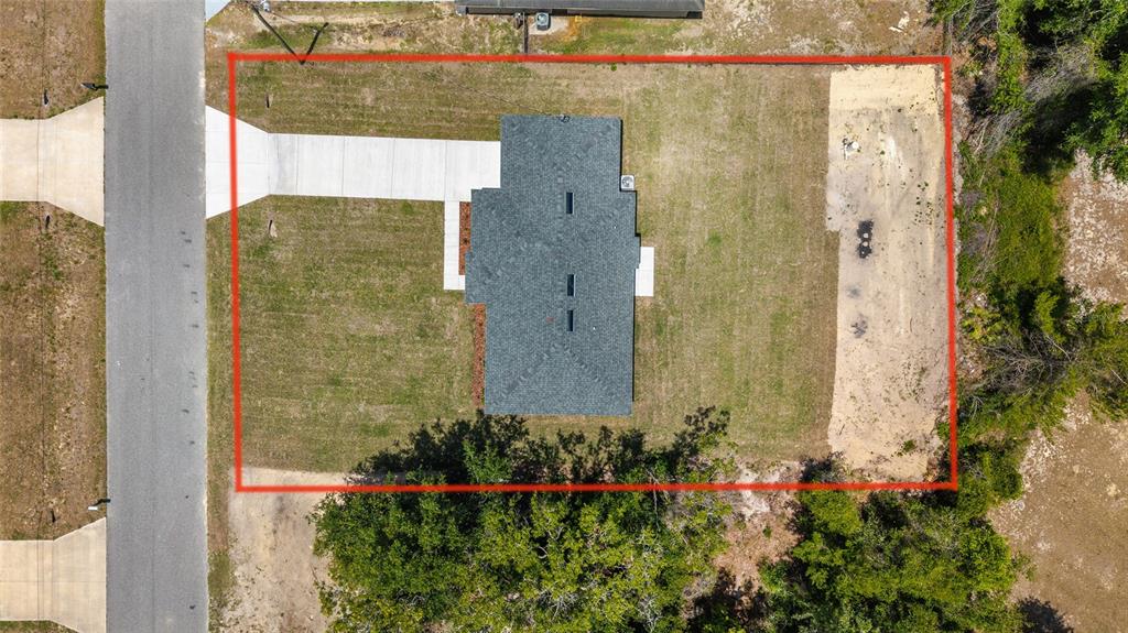 29 Olive Cir Loop Ocala, FL 34472 - Photo 41 of 49 a view of a brick house with a flower garden