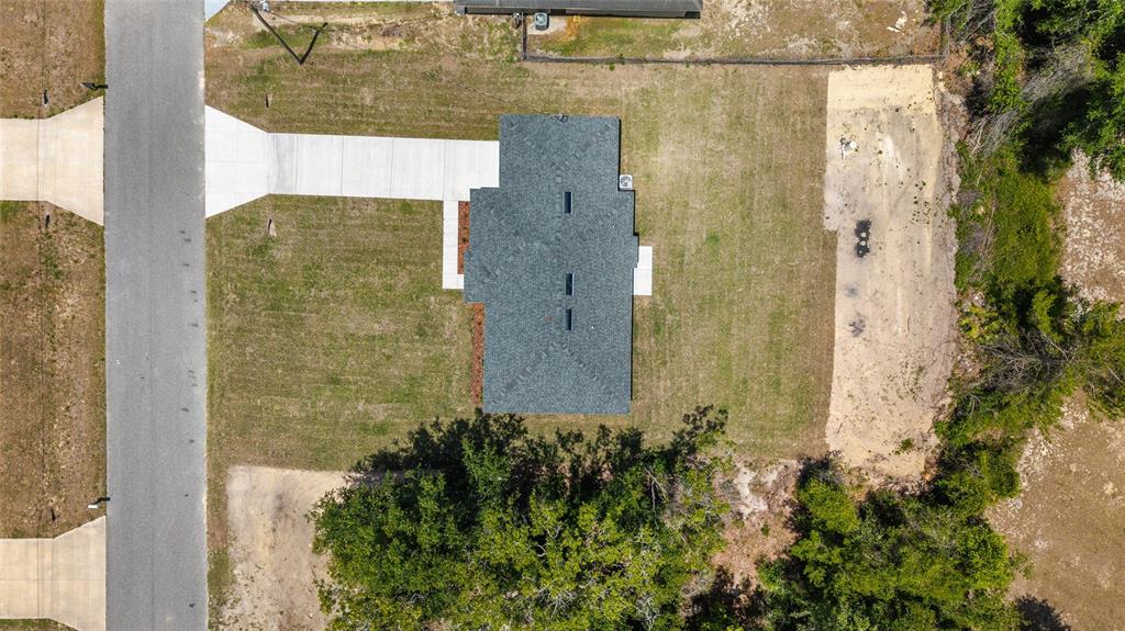 29 Olive Cir Loop Ocala, FL 34472 - Photo 42 of 49 a brick building with a yard