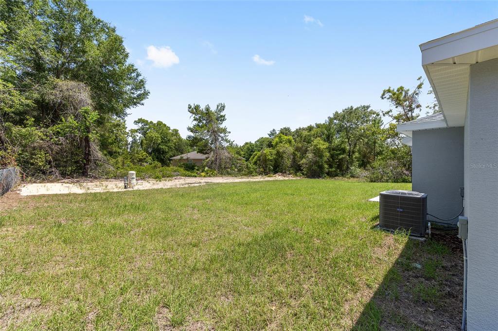 29 Olive Cir Loop Ocala, FL 34472 - Photo 7 of 49 a view of a green field with wooden fence