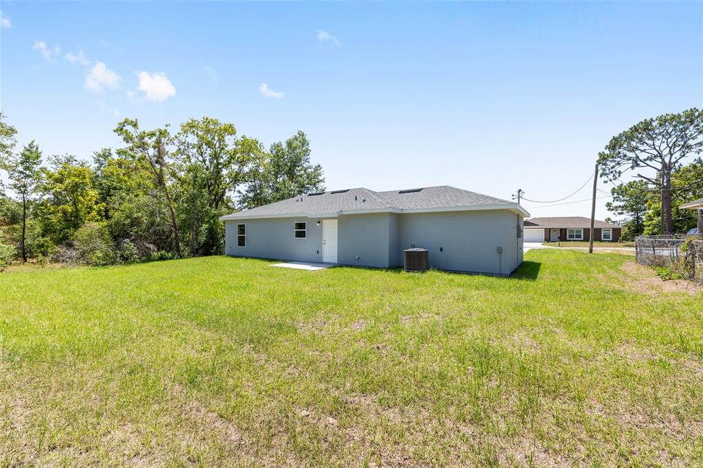 29 Olive Cir Loop Ocala, FL 34472 - Photo 8 of 49 a view of a house with a yard and sitting area