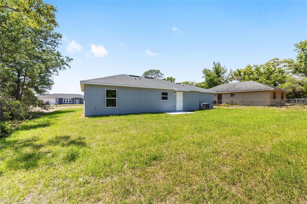 29 Olive Cir Loop Ocala, FL 34472 - Photo 10 of 49 a front view of house with yard and garage