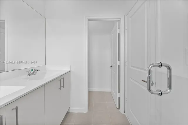 a bathroom with a double vanity sink a toilet and shower