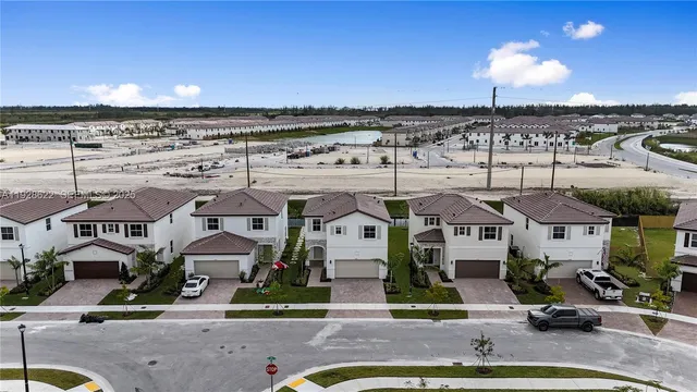 an aerial view of residential houses with outdoor space