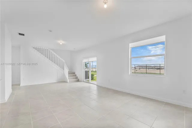 a view of an empty room with a window