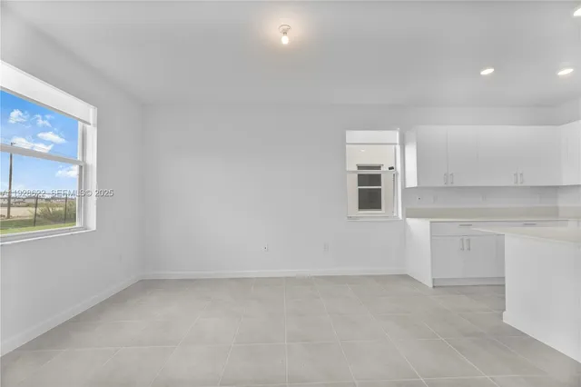 wooden floor in an empty room and a window