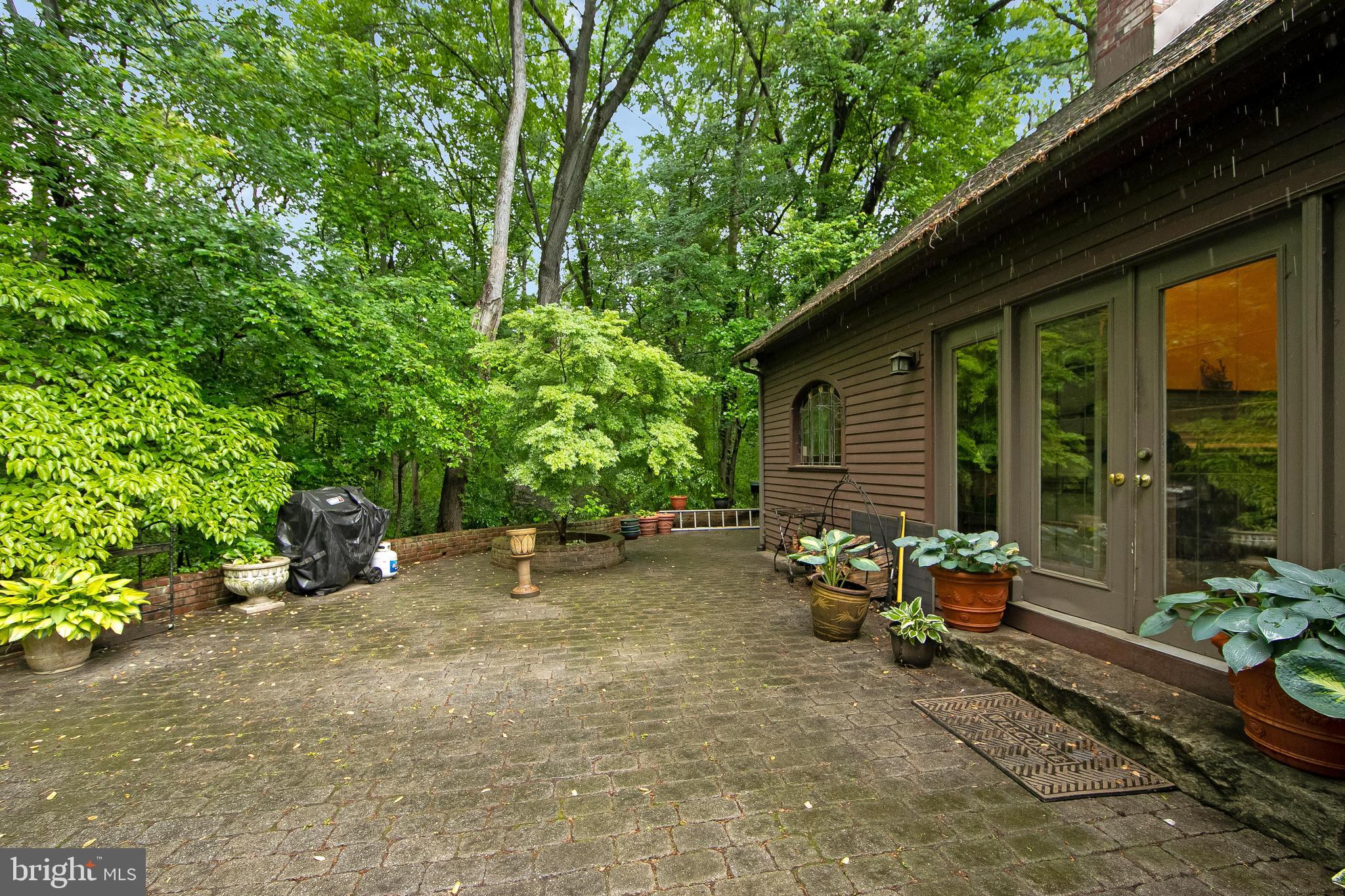 51 E Road Gibbsboro, NJ 08026 - Photo 9 of 42 a backyard of a house with table and chairs and potted plants
