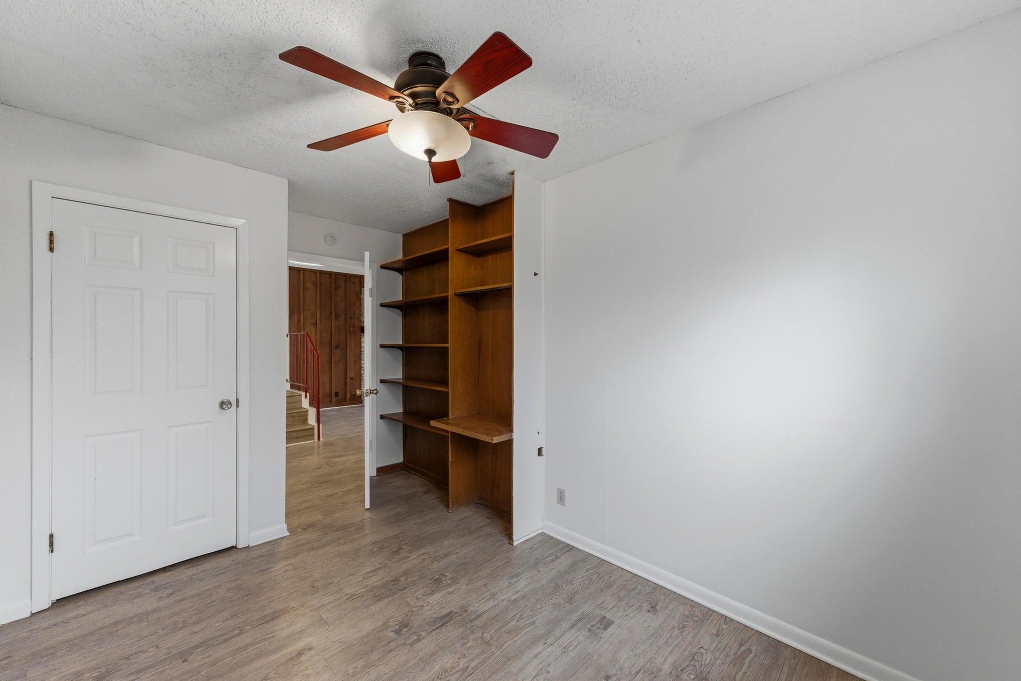 2711 St Edwards Circle Austin, TX 78704 - Photo 34 of 40 The downstairs bedroom for Unit 2 (here, looking to the living room) has a built-in desk and shelves.