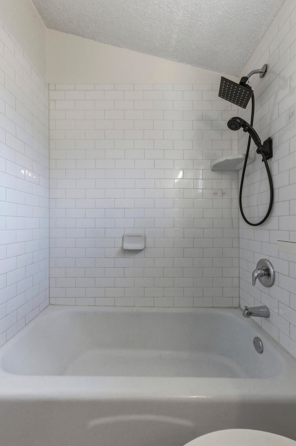 2711 St Edwards Circle Austin, TX 78704 - Photo 7 of 40 The bathroom for unit 1 has lovely subway-tile updates.