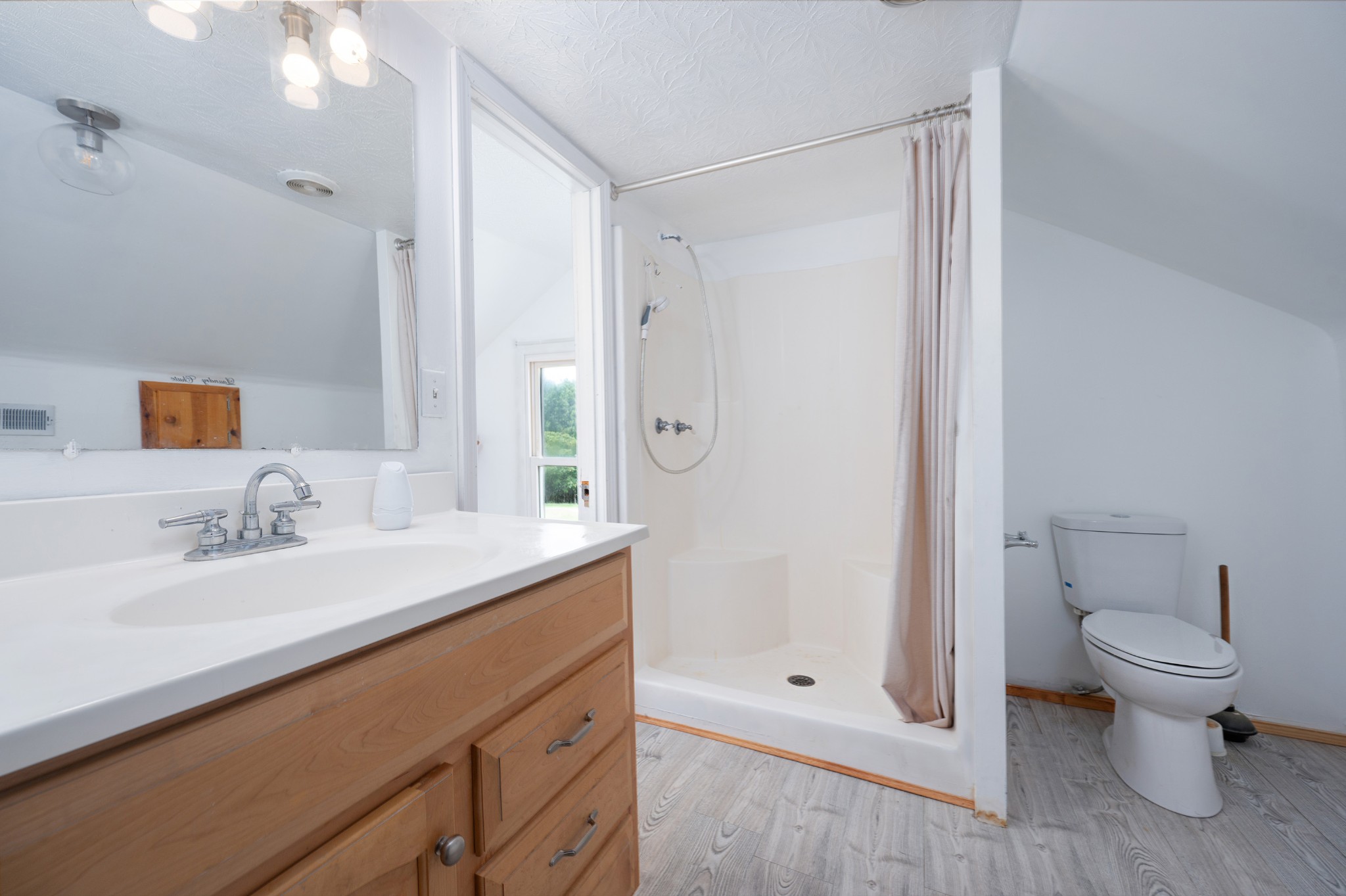 847 Chaffin Road Lafayette, TN 37083 - Photo 19 of 42 a bathroom with a granite countertop sink a toilet and shower