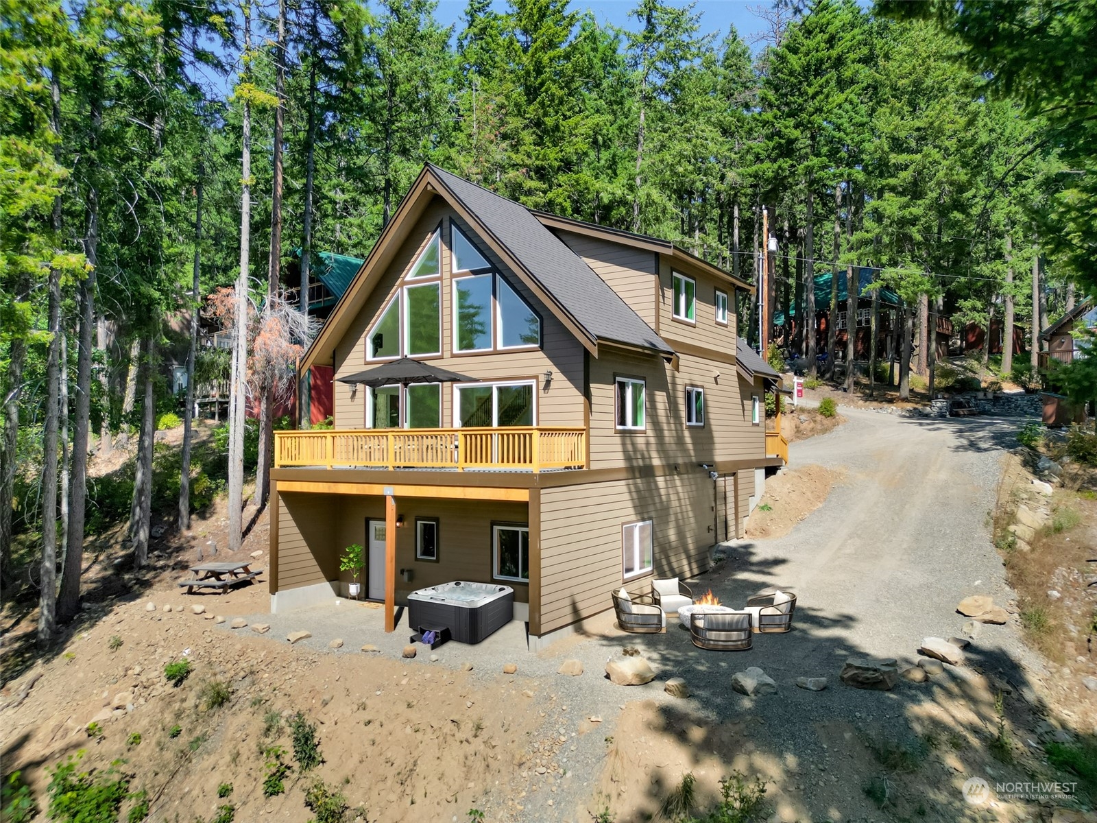 a view of house with yard outdoor seating and covered with trees