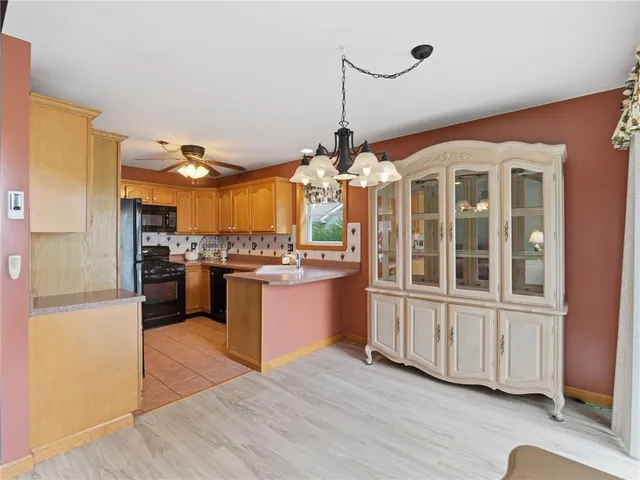 a kitchen with granite countertop stainless steel appliances and wooden floor