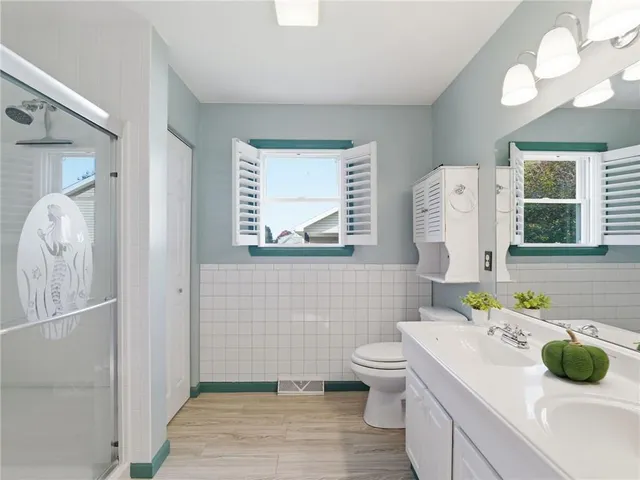 a bathroom with a sink toilet and mirror