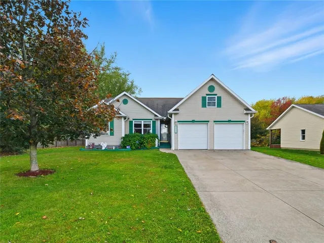 a front view of a house with a yard and trees