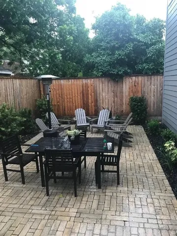 a backyard of a house with table and chairs