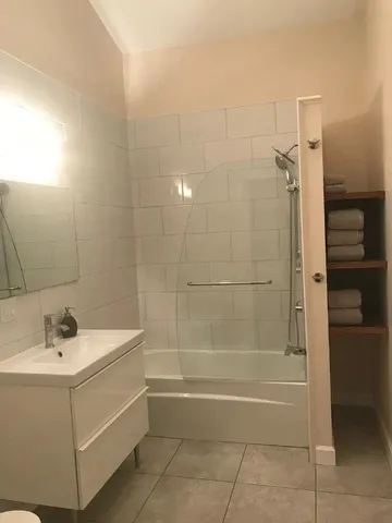 a bathroom with a sink a mirror and a bathtub